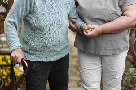 helping elderly walk